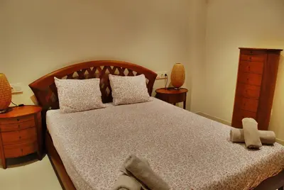 a bedroom with a large bed with two night stands at Apartaments Can Negret in Sitges