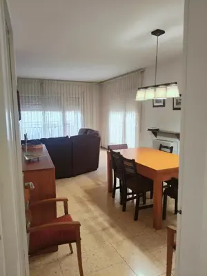 a living room with a table and a couch at Apartamento duplex vacacional in Arenys de Mar