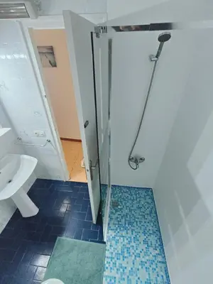 a bathroom with a shower with a toilet and a sink at Apartamento duplex vacacional in Arenys de Mar