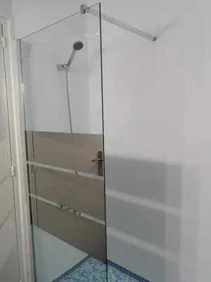 a shower with a glass door in a bathroom at Apartamento duplex vacacional in Arenys de Mar