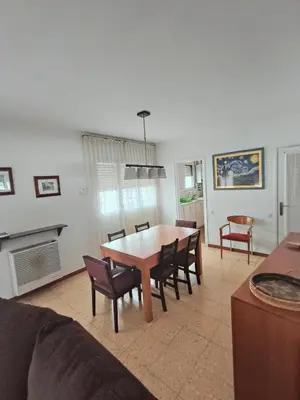 a living room with a dining room table and chairs at Apartamento duplex vacacional in Arenys de Mar