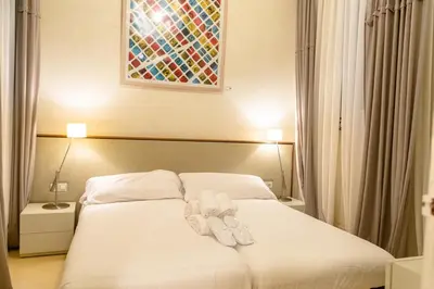 a bedroom with a bed with two towels on it at B&B Boutique Ca La Maria in Barcelona