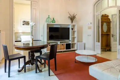 a living room with a table and a tv at B&B Boutique Ca La Maria in Barcelona