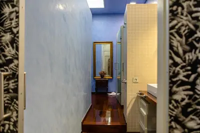 a hallway of a bathroom with a mirror and a sink at B&B Boutique Ca La Maria in Barcelona