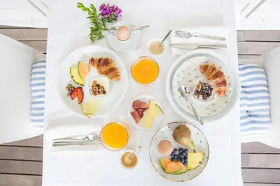 a table with plates of breakfast foods on it at B&B Boutique Ca La Maria in Barcelona