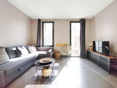 a living room with a couch and a table at Bo&Co Apartments in Sitges