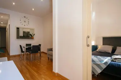 a bedroom with a bed and a dining room with a table at Cute Apartment in Barcelona