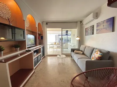 a living room with a couch and a table at Duplex oasis in Sitges