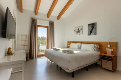 a bedroom with a large bed and a window at Villa Masia Capdet in Sant Pere de Ribes