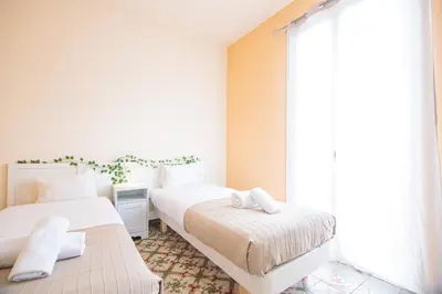 a bedroom with two beds and a large window at Be barcelona arco del triunfo sunny colors 2 in Barcelona