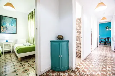 a hallway with a green cabinet in a room with a bed at Be barcelona arco del triunfo sunny colors 2 in Barcelona