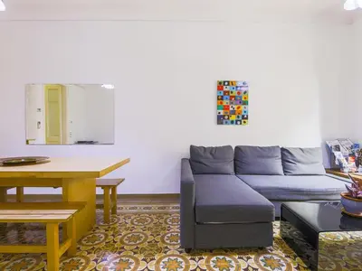 a living room with a couch and a table at Be barcelona arco del triunfo sunny colors in Barcelona