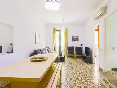 a living room with a table and a couch at Be barcelona arco del triunfo sunny colors in Barcelona