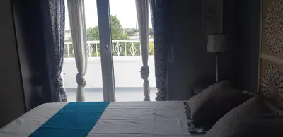 a bedroom with a bed and a large window at Edard's Private Villa in Castelldefels