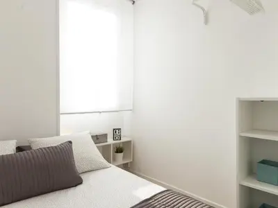 a bedroom with a bed and a window at Lets holidays apartment in Sant Martí in Barcelona