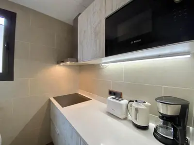 a kitchen with a counter with a coffee maker on it at Sagrada familia apartment in Barcelona