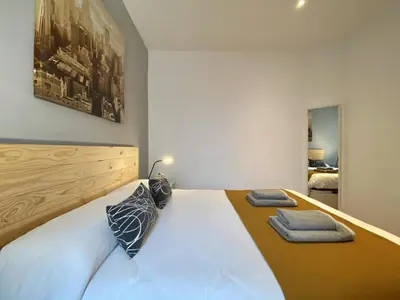 a bedroom with a bed with two pillows on it at Sagrada familia apartment in Barcelona
