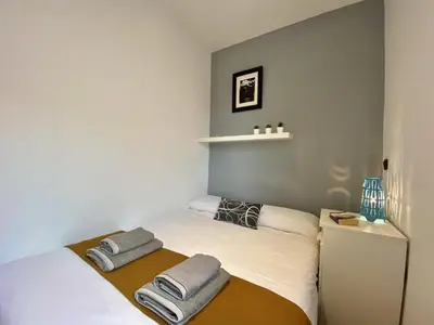 two beds in a small room with towels on them at Sagrada familia apartment in Barcelona