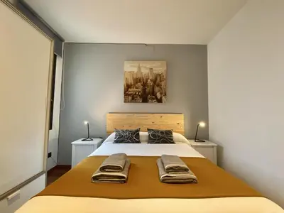 a bedroom with a bed with two towels on it at Sagrada familia apartment in Barcelona