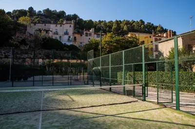 a tennis court with a net on a tennis court at Hotel Robert in La Pobla de Claramunt