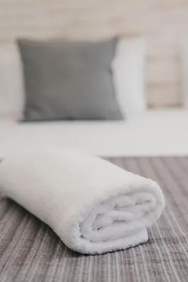 a white towel sitting on the floor in a bathroom at BBarcelona Fira Superior Flats in Barcelona