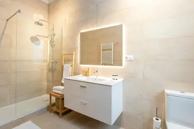 a bathroom with a white sink and a shower at Canela Homes BARCELONA MARINA in Barcelona