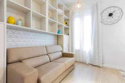 a living room with a couch and a window at Canela Homes BARCELONA MARINA in Barcelona
