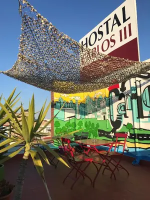 a restaurant with a table and chairs and a sign at Hostal Carlos III in El Prat de Llobregat