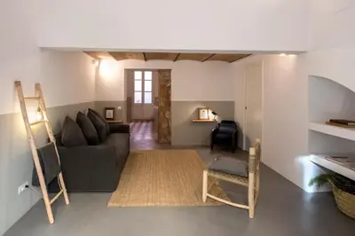 a living room with a couch and a chair at CASA FILOMENA in Barcelona