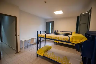 a room with two bunk beds and a table at Alberg Barcelona Xanascat in Barcelona