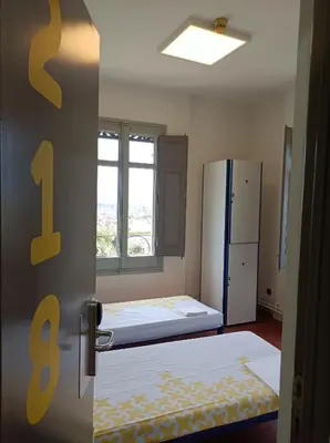 an open door to a room with a refrigerator at Alberg Barcelona Xanascat in Barcelona