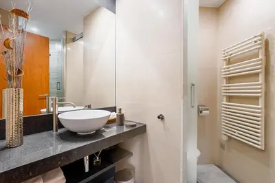 a bathroom with a sink and a mirror at Lodging Apartments City Center-Eixample in Barcelona