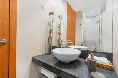 a bathroom with a bowl sink on a counter at Lodging Apartments City Center-Eixample in Barcelona