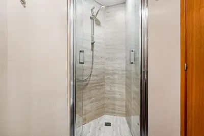 a shower with a glass door in a bathroom at Lodging Apartments City Center-Eixample in Barcelona
