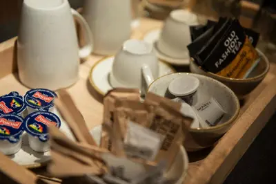 a wooden table topped with dishes and cups on a table at Hotel California in Barcelona