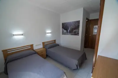 a hotel room with two beds in a room at Turó de L´Home in Santa María de Palautordera