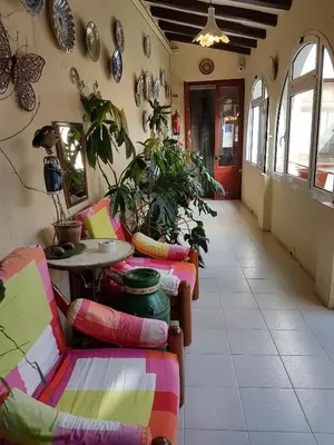a room with couches and a table and chairs at Turó de L´Home in Santa María de Palautordera