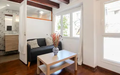 a living room with a couch and a table at Pedrera - Gràcia in Barcelona