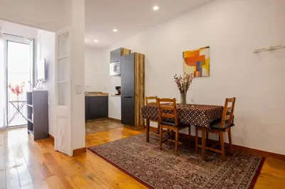 a kitchen and dining room with a table and chairs at Pedrera - Gràcia in Barcelona