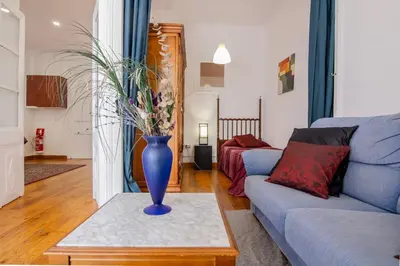 a living room with a blue vase on a table at Pedrera - Gràcia in Barcelona