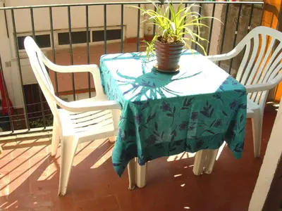 a table with two chairs and a potted plant on it at Pedrera - Gràcia in Barcelona
