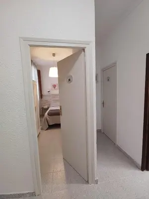 a hallway with a door leading to a bedroom at Hostal Dragonflybcn in Barcelona