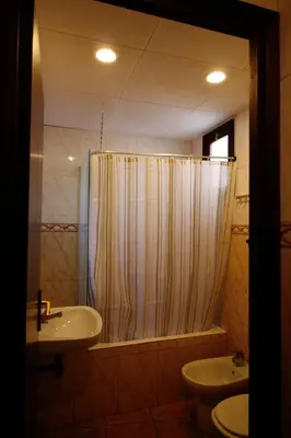 a bathroom with a shower and a sink and a toilet at Hostal Dragonflybcn in Barcelona