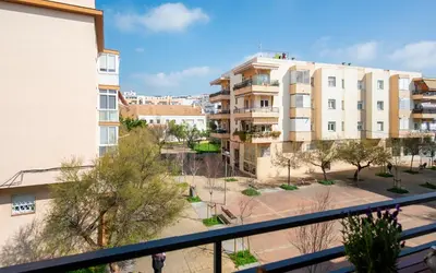 a balcony with chairs and a table and a view at BONITO APARTAMENTO in Sitges