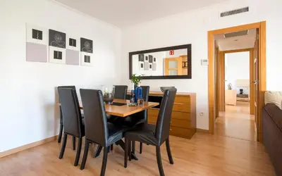 a white bathroom with a toilet and a sink at BONITO APARTAMENTO in Sitges