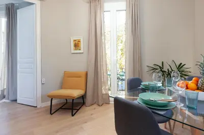 a dining room with a glass table and chairs at My Address on the Beach and Sun in Barcelona