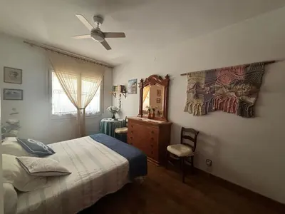 a bedroom with a bed and a ceiling fan at Calella Playa in Calella