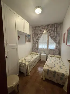 a bedroom with two beds and a window at Calella Playa in Calella