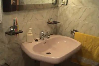 a bathroom with a white sink and a mirror at Calella Playa in Calella