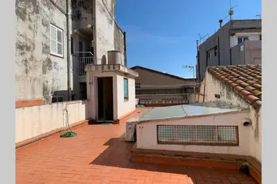 an outside view of a building with a roof at Calella Playa in Calella